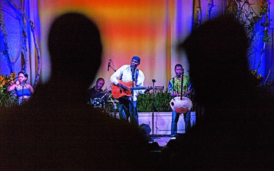 two shadows looked at a singer on the stage 
