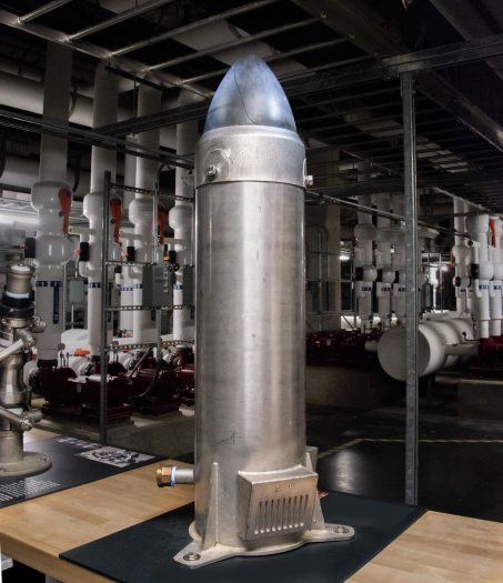 A large rocket-shaped metal piece of machinery in an underground pumproom