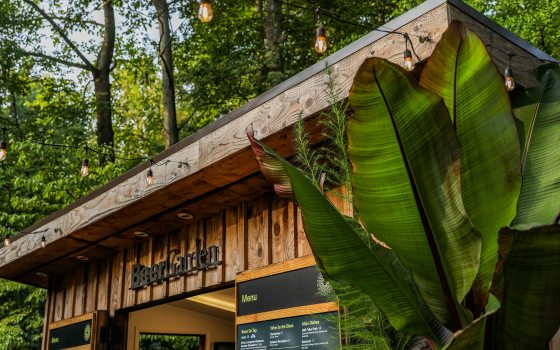 brown wooden outdoor hut with party lights and words "Beer Garden" across front