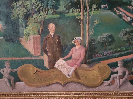 oil painting of two people sitting in a garden with a gold placque that reads Longwood PA 1936
