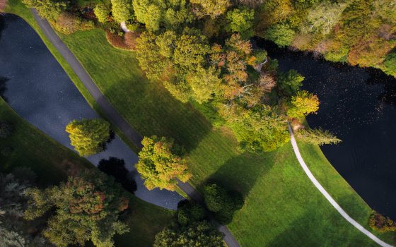 Aerial view of green areas with a small lake to the left and a larger lake to the right