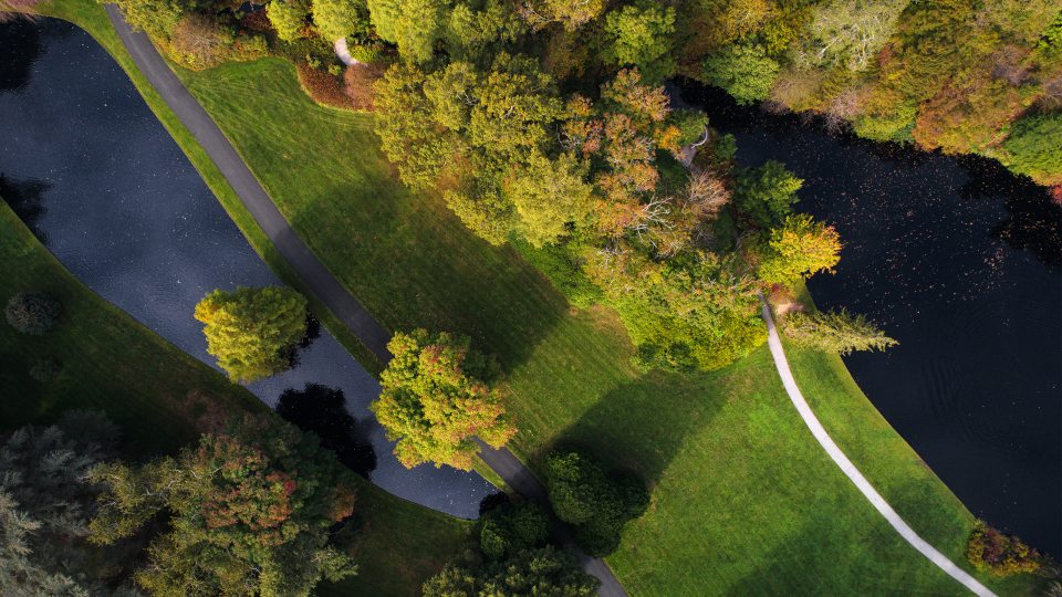 Aerial view of green areas with a small lake to the left and a larger lake to the right
