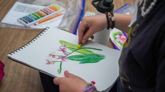 closeup of youth doing a botanical drawing
