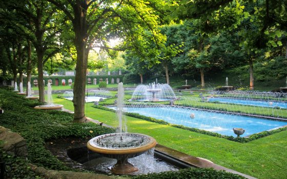 A fountain garden with multiple polls and a central stone fountain