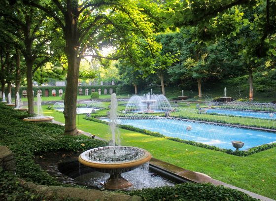 A fountain garden with multiple polls and a central stone fountain