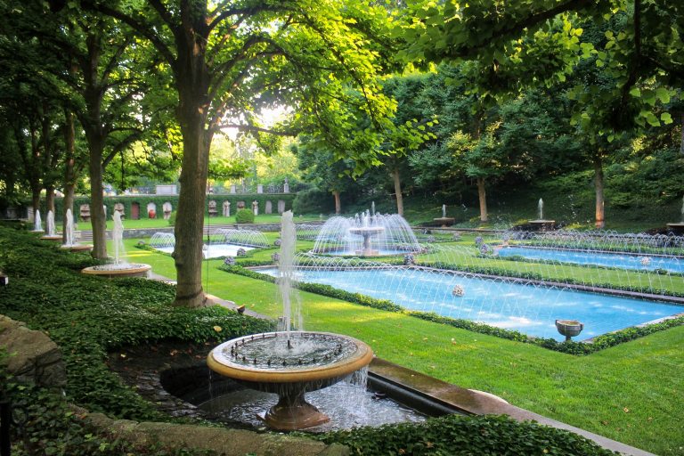 A fountain garden with multiple polls and a central stone fountain