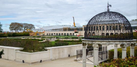 A scene at Longwood Gardens with a love temple in the foreground and a construction site in the background.