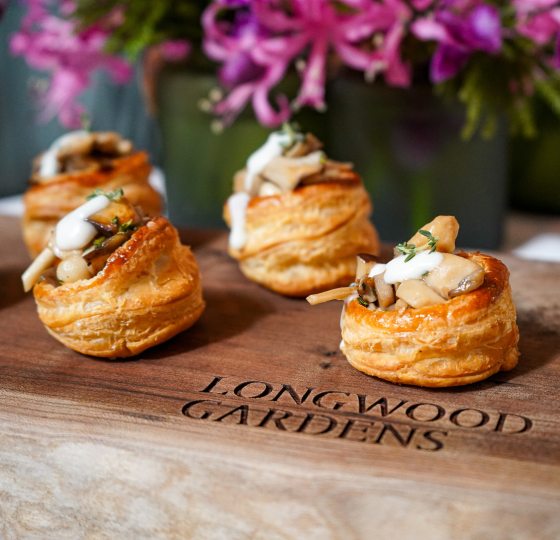 Four round pastries displayed on a wooden board.