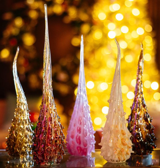 Five blown glass pieces resting on a table part of A Longwood Christmas. 