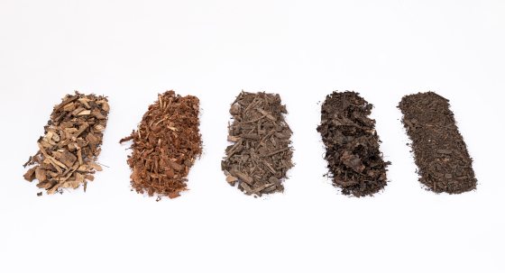 Five lines of various soil amendments ranging from tan to reddish brown and black. 