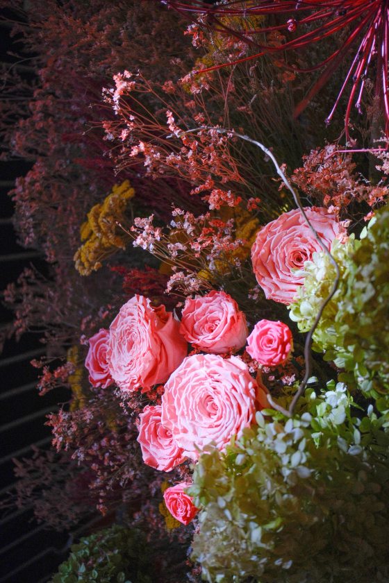 An arrangement of preserved flowers, featuring bright pink roses.