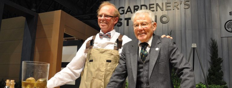 two individuals pose together at the Philadelphia Flower Show